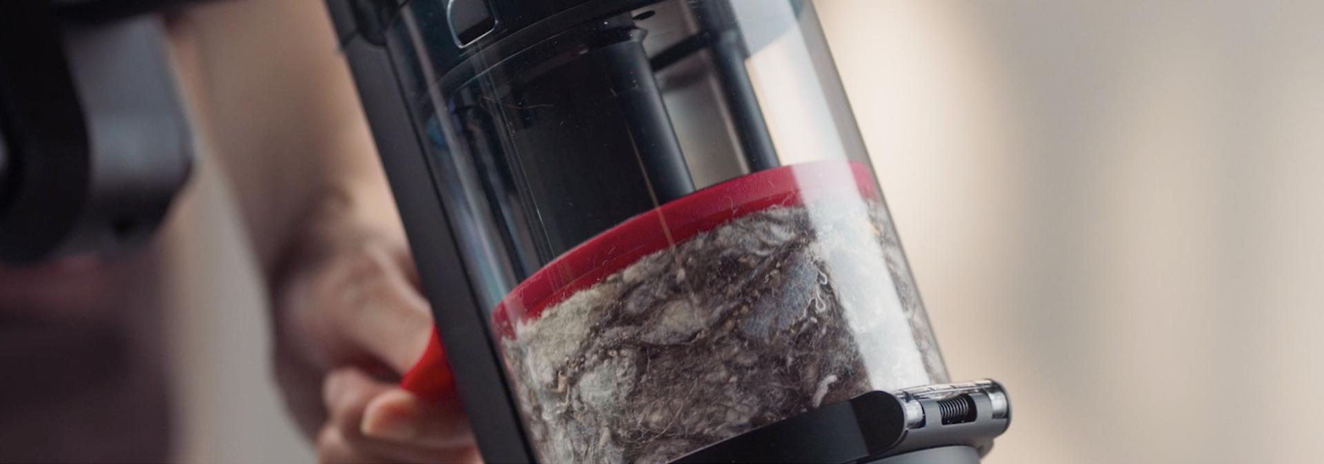 A closeup of the vacuum's bin, full of debris.