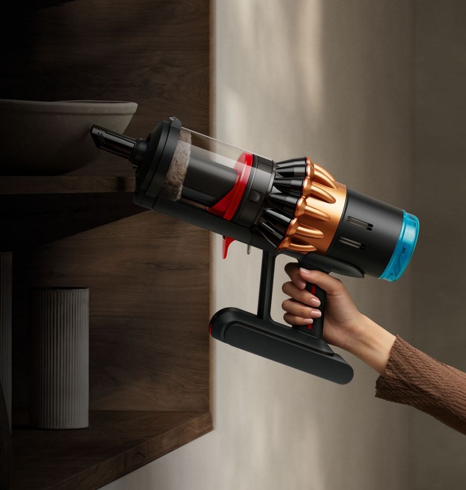 The built-in crevice tool being used to clean around a table.
