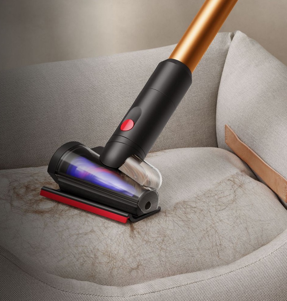 The hair screw tool of the Dyson Piston Animal vacuum being used to clean up hair from upholstery.