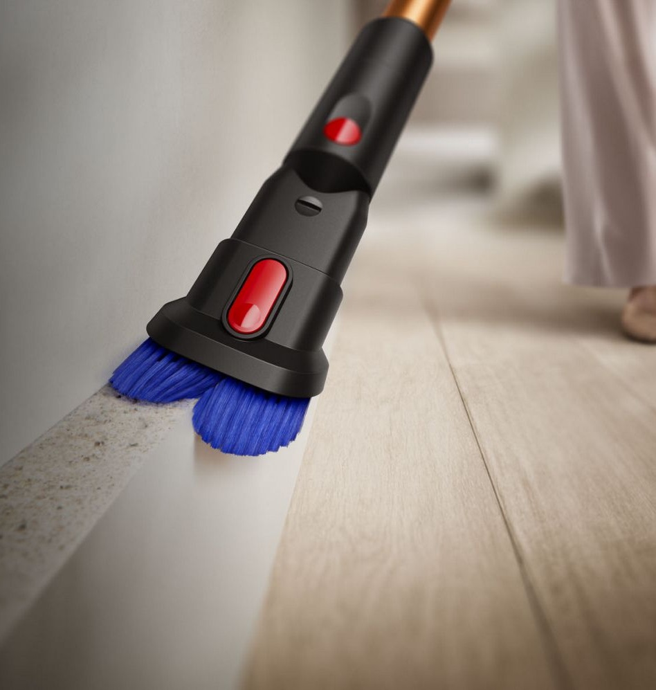 The combi tool of the Dyson Piston Animal vacuum being used to clean around a skirting board.